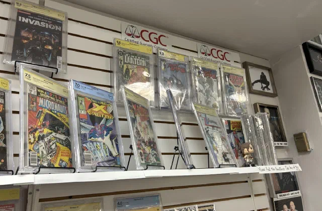 Graded and slabbed comics displayed on a wall rack